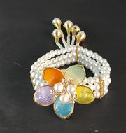NMII Designer Plastic Pearl Bracelet For Women & Girls With Multicolor Flower Charm | Gold Tone Finish, Gemstone & Pearl Bead Work | Beautiful Hand Bracelet For Wedding, Party, Festival & Festive